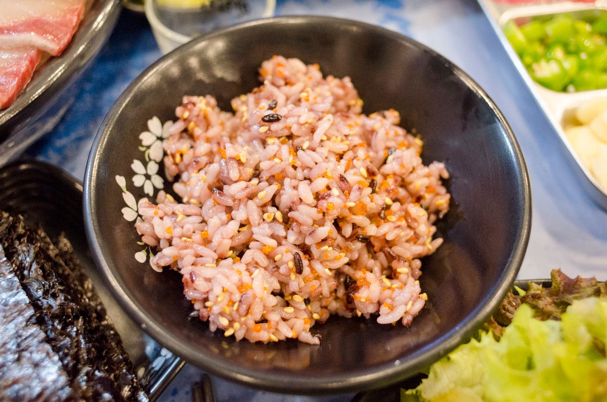 Rice with vegetables served in a black bowl